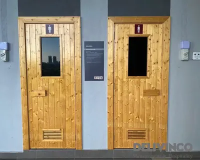 two wooden doors on the side of a building at Trion - KL - 2BR - 6pax - 15min to KLCC & TRX in Kuala Lumpur