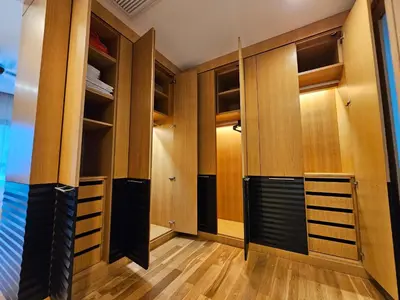 a walk in closet with wooden doors and shelves at Luxurious Apartment St Mary Residences Resort Style in Kuala Lumpur