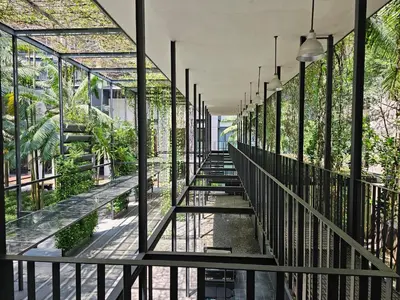 a glass walkway in a building with plants at Luxurious Apartment St Mary Residences Resort Style in Kuala Lumpur