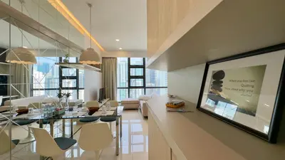 a living room with a table and chairs in a room at Extravagant Family-Biz Nest @ Robertson 30F in Kuala Lumpur