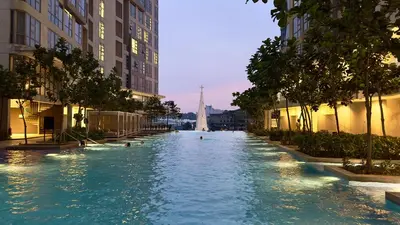 a swimming pool in a city with people swimming in it at Extravagant Family-Biz Nest @ Robertson 30F in Kuala Lumpur