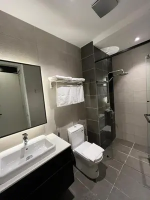 a bathroom with a toilet and a sink and a shower at Bukit Bintang Axon Residences 3R2B 3Queens Beds in Kuala Lumpur
