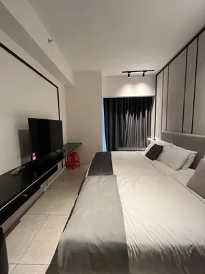 a bedroom with a large bed and a flat screen tv at Bukit Bintang Axon Residences 3R2B 3Queens Beds in Kuala Lumpur