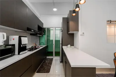 a kitchen with white counter tops and brown cabinets at Razak City Residence by Lisa Homestay in Kuala Lumpur