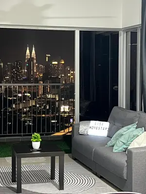 a living room with a couch and a view of a city at Razak City Residence by Lisa Homestay in Kuala Lumpur