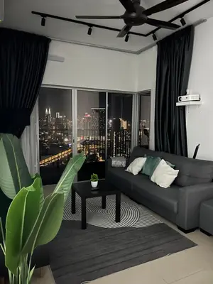a living room with a couch and a city skyline at Razak City Residence by Lisa Homestay in Kuala Lumpur