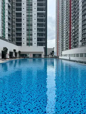 a large blue swimming pool with two tall buildings at Razak City Residence by Lisa Homestay in Kuala Lumpur