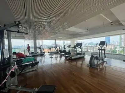 a gym with people exercising on machines in a building at D'Majestic Kuala Lumpur By Luxe Home in Kuala Lumpur