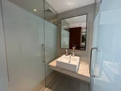 a bathroom with a sink and a glass shower at D'Majestic Kuala Lumpur By Luxe Home in Kuala Lumpur