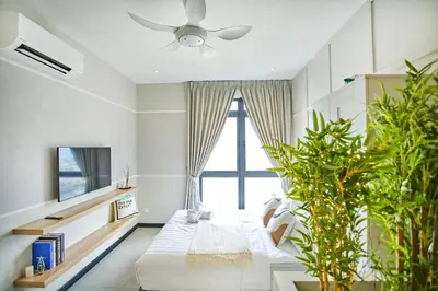 a living room with a couch and a large window at Neu Suites Ampang near LRT Jelatek in Kuala Lumpur