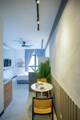 a room with a table and chairs and a bedroom at Neu Suites Ampang near LRT Jelatek in Kuala Lumpur