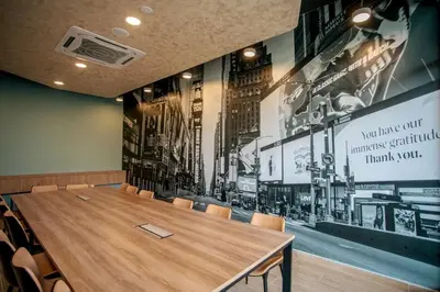 a conference room with a wooden table and chairs at Neu Suites Ampang near LRT Jelatek in Kuala Lumpur