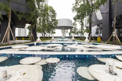 a pool of water in a building with trees at Arena Gaming Suite In Arte Mont Kiara in Kuala Lumpur