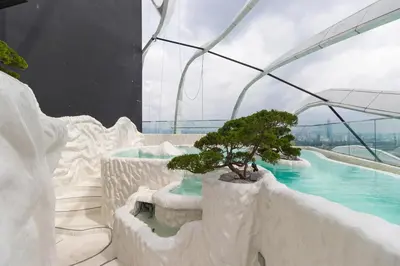 a bonsai tree in a building with a swimming pool at Arena Gaming Suite In Arte Mont Kiara in Kuala Lumpur