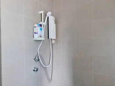 a shower in a bathroom with a phone on the wall at Mercu Summer Suites KLCC 2BR Pastel Rose in Kuala Lumpur