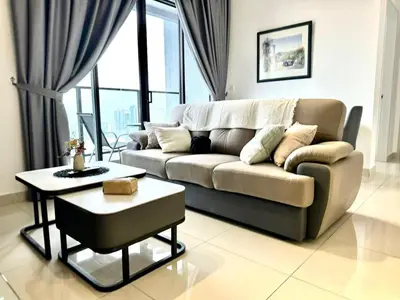 a living room with a couch and a table at 3R3B KLCity CentreView (Balcony) - 8 pax in Kuala Lumpur