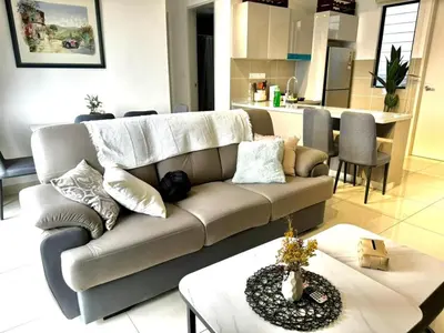 a living room with a couch and a table at 3R3B KLCity CentreView (Balcony) - 8 pax in Kuala Lumpur