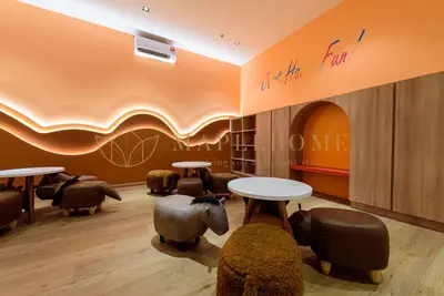 a waiting room with tables and chairs and writing on the wall at Trion Premier Suites Kuala Lumpur in Kuala Lumpur