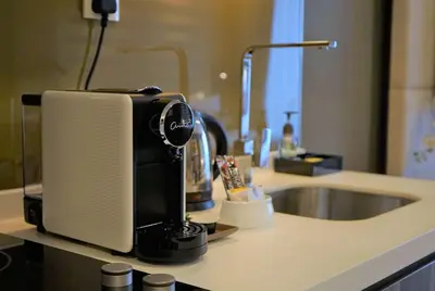 a coffee maker sitting on a counter next to a sink at Ramada Suites by Wyndham Kuala Lumpur City Centre in Kuala Lumpur