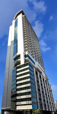a tall building with a lot of windows at Ramada Suites by Wyndham Kuala Lumpur City Centre in Kuala Lumpur