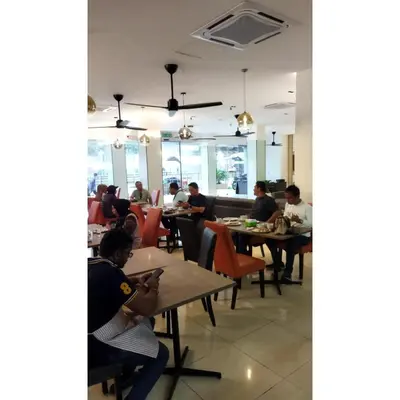a group of people sitting at tables in a restaurant at Sakura Elite Kuala Lumpur in Kuala Lumpur