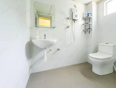 a white bathroom with a sink and a toilet at Cozy Place-Rumah Nyaman - Bukit Bintang by Shine Stay in Kuala Lumpur