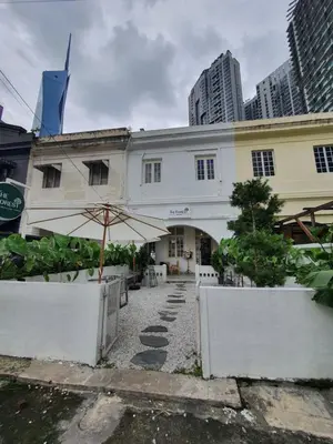 a white building with an umbrella and some buildings at Cozy Place-Rumah Nyaman - Bukit Bintang by Shine Stay in Kuala Lumpur