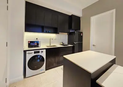 a kitchen with a washing machine and a sink at Axon Suite Bukit Bintang 3Bed Room Suites ,5min Pavillion KL in Kuala Lumpur