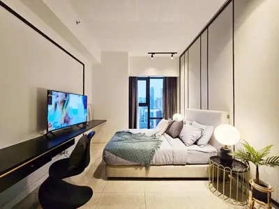 a bedroom with a bed and a flat screen tv at Axon Suite Bukit Bintang 3Bed Room Suites ,5min Pavillion KL in Kuala Lumpur