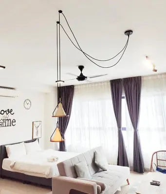 a living room with a bed and a couch at Arte plus by studio sweet home in Batu Empat