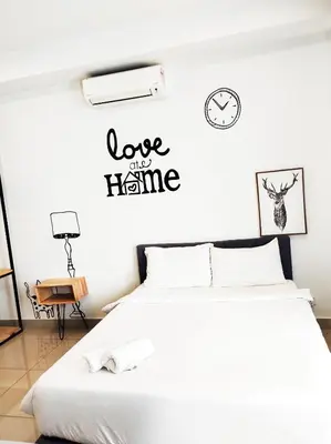 a bedroom with a bed and a clock on the wall at Arte plus by studio sweet home in Batu Empat