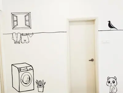 a bathroom with a wall with drawings of a washing machine at Arte plus by studio sweet home in Batu Empat