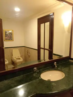 a bathroom with a sink and a toilet and a mirror at Times Square Apartment By Skyline in Kuala Lumpur
