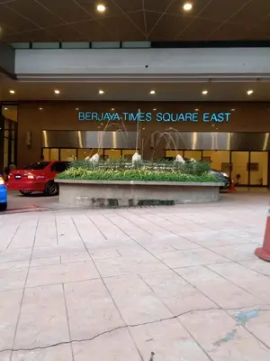 a building with a fountain in the middle of a parking lot at Times Square Apartment By Skyline in Kuala Lumpur