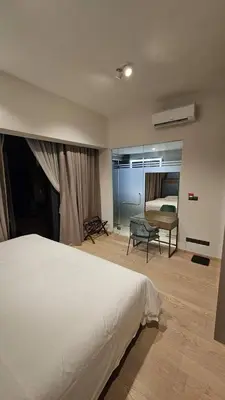 a bedroom with a large white bed and a chair at Star Residence Pool View 2br Unit Floor 8 in Kuala Lumpur