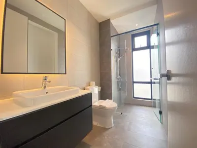 a bathroom with a sink and a toilet and a mirror at The Axon Bukit Bintang Residence by De Space in Kuala Lumpur