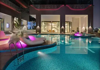a large swimming pool with purple chairs and a swimming pool at FHS Homestay @ Arte Plus Jalan Ampang T1-40-02 in Kuala Lumpur