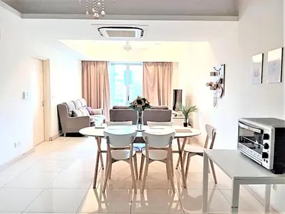 a living room with a dining room table and chairs at Suasana Suites KLCC Bukit Ceylon in Kuala Lumpur