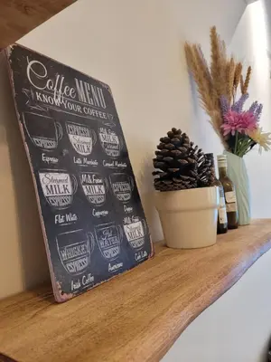 a shelf with a sign and a plant on it at OOAK Residence at Mont Kiara in Kuala Lumpur