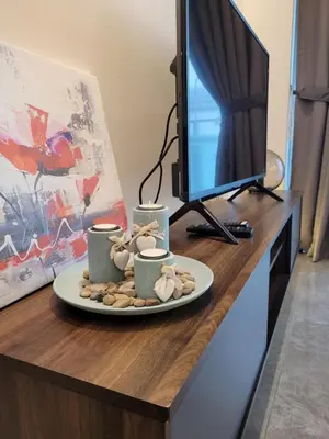 a desk with two coffee cups and a computer monitor at OOAK Residence at Mont Kiara in Kuala Lumpur