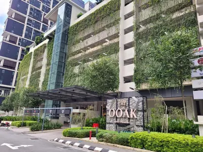 an office building with a green wall on it at OOAK Residence at Mont Kiara in Kuala Lumpur