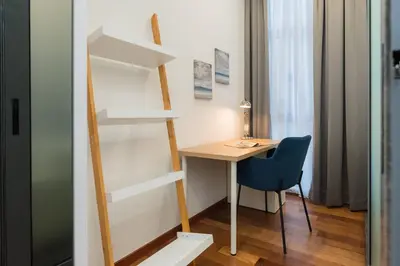 a room with a desk and a chair next to a book shelf at Royce Residence KLCC by Cobnb in Kuala Lumpur
