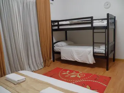 a room with two bunk beds and a bed at Maytower Apartment in Kuala Lumpur