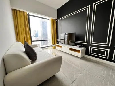 a living room with a couch and a television at Axon Bukit Bintang By Moonlight in Kuala Lumpur