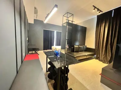 a living room with a glass table and a couch at Axon Bukit Bintang By Moonlight in Kuala Lumpur