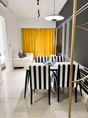 a living room with a table and chairs and a couch at Axon Bukit Bintang By Moonlight in Kuala Lumpur