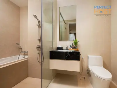 a bathroom with a toilet and a sink and a shower at Pavilion Ceylon Hill Suites, KLCC in Kuala Lumpur
