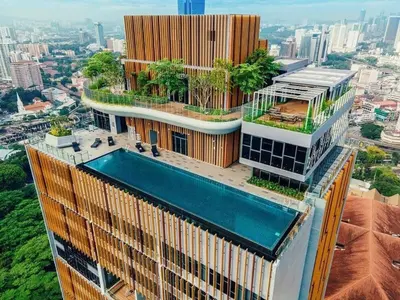 a building with a swimming pool on top of it at Ceylonz Suite Kuala Lumpur Bukit Bintang in Kuala Lumpur