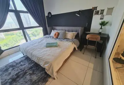 a bedroom with a large bed with a large window at Designer Studio Arte Mont Kiara in Kuala Lumpur