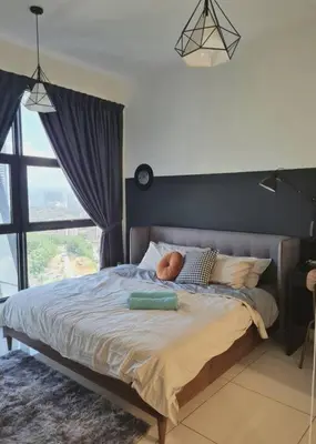a bedroom with a large bed with a large window at Designer Studio Arte Mont Kiara in Kuala Lumpur